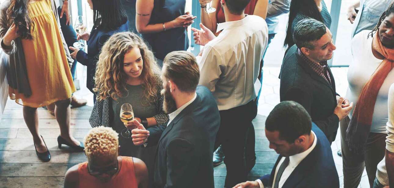 Professionals networking at a business event—a visual example of AI flexibility in Cincinnati freeing up time for real-world connections.”