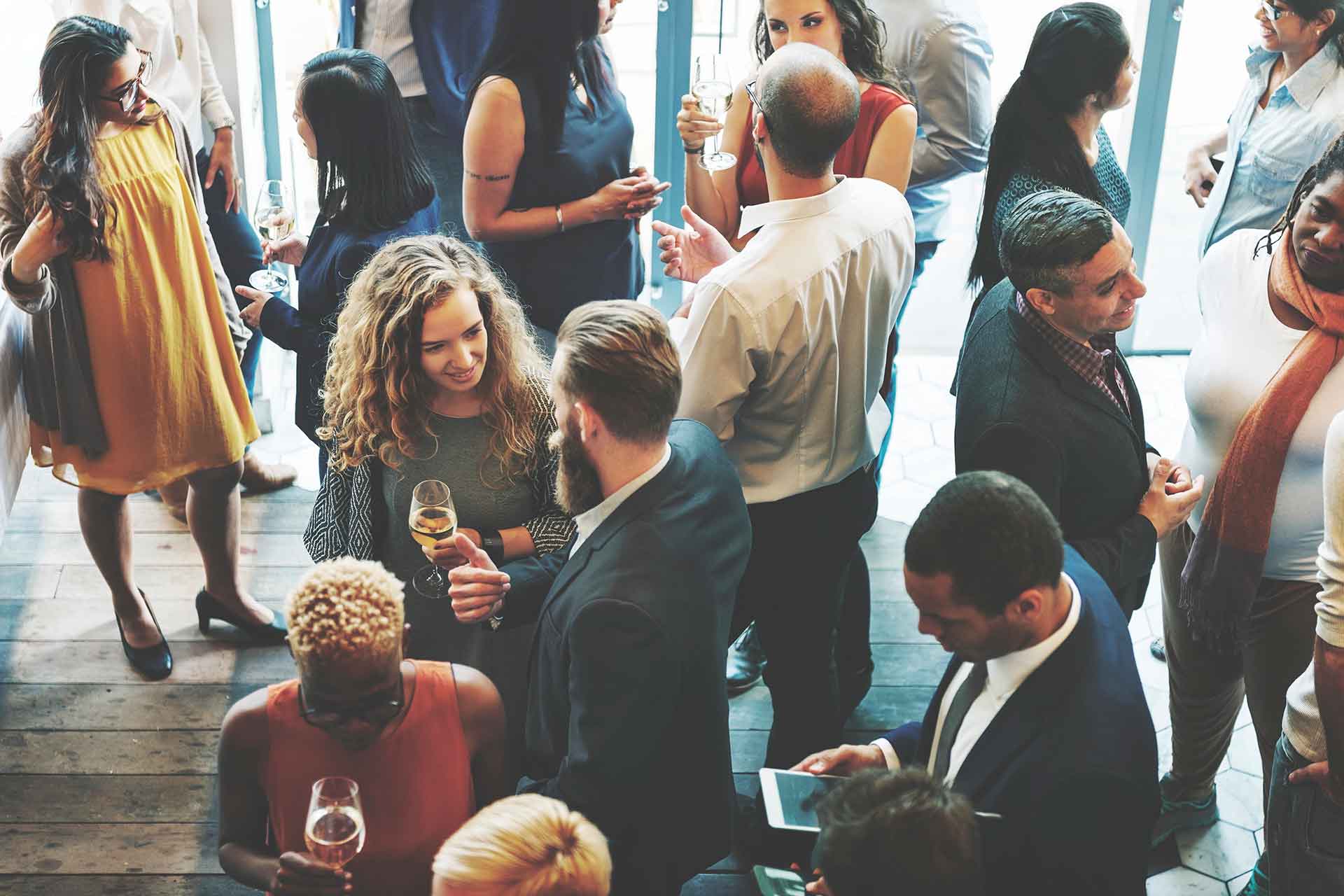 Professionals networking at a business event—a visual example of AI flexibility in Cincinnati freeing up time for real-world connections.”