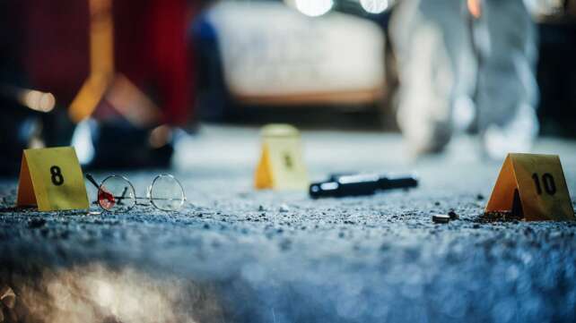 “Crime scene evidence markers on a Cincinnati street, symbolizing the city’s rising violent crime crisis.