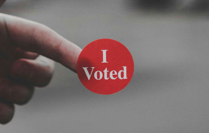 A voter’s finger with an ‘I Voted’ sticker after participating in early voting.