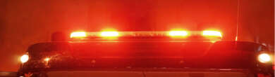 Illuminated red emergency light bar on a fire truck that represents as responding to a night fire in Cincinnati.