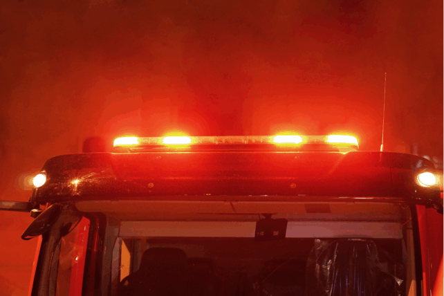 Illuminated red emergency light bar on a fire truck that represents as responding to a night fire in Cincinnati.