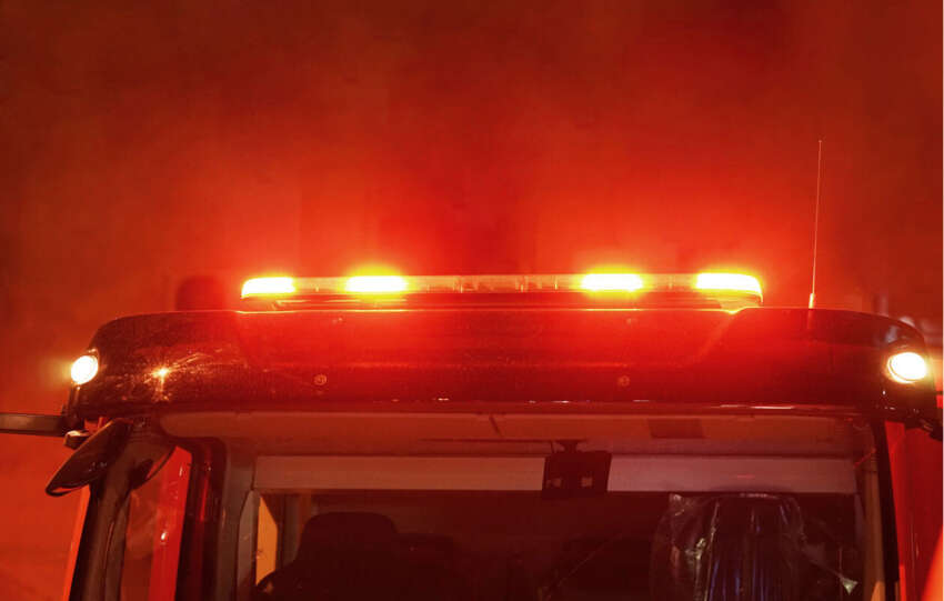 Illuminated red emergency light bar on a fire truck that represents as responding to a night fire in Cincinnati.