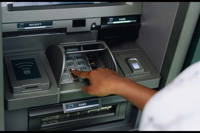 A person using an ATM machine, illustrating the ATM-skimming fraud case in Cincinnati.