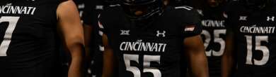 Cincinnati Bearcats football players walk through the stadium tunnel with their heads down after the Cincinnati vs TCU game.