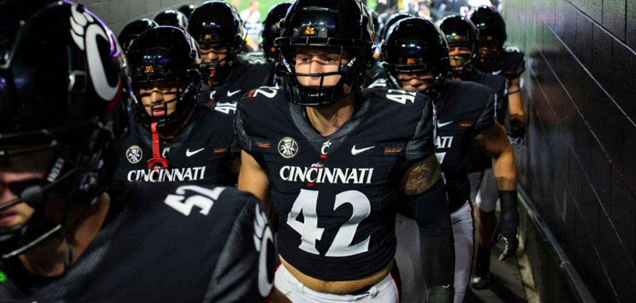 Cincinnati Bearcats football team running onto the field before Arizona Wildcats matchup as playoff hopes stay alive