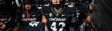 Cincinnati Bearcats football team running onto the field before Arizona Wildcats matchup as playoff hopes stay alive