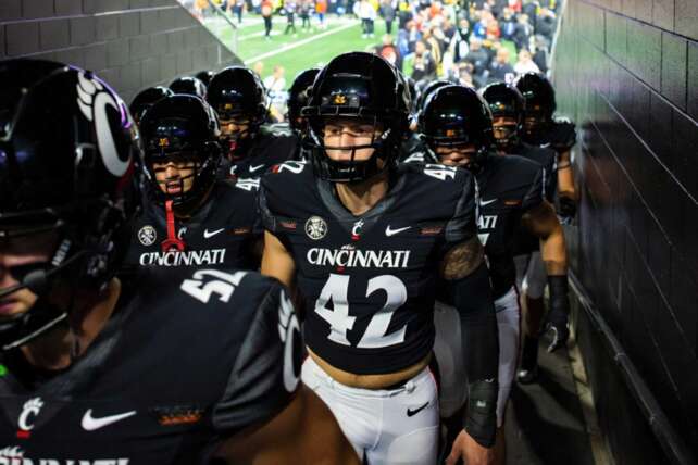 Cincinnati Bearcats football team running onto the field before Arizona Wildcats matchup as playoff hopes stay alive