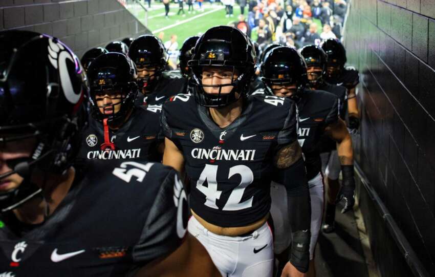 Cincinnati Bearcats football team running onto the field before Arizona Wildcats matchup as playoff hopes stay alive