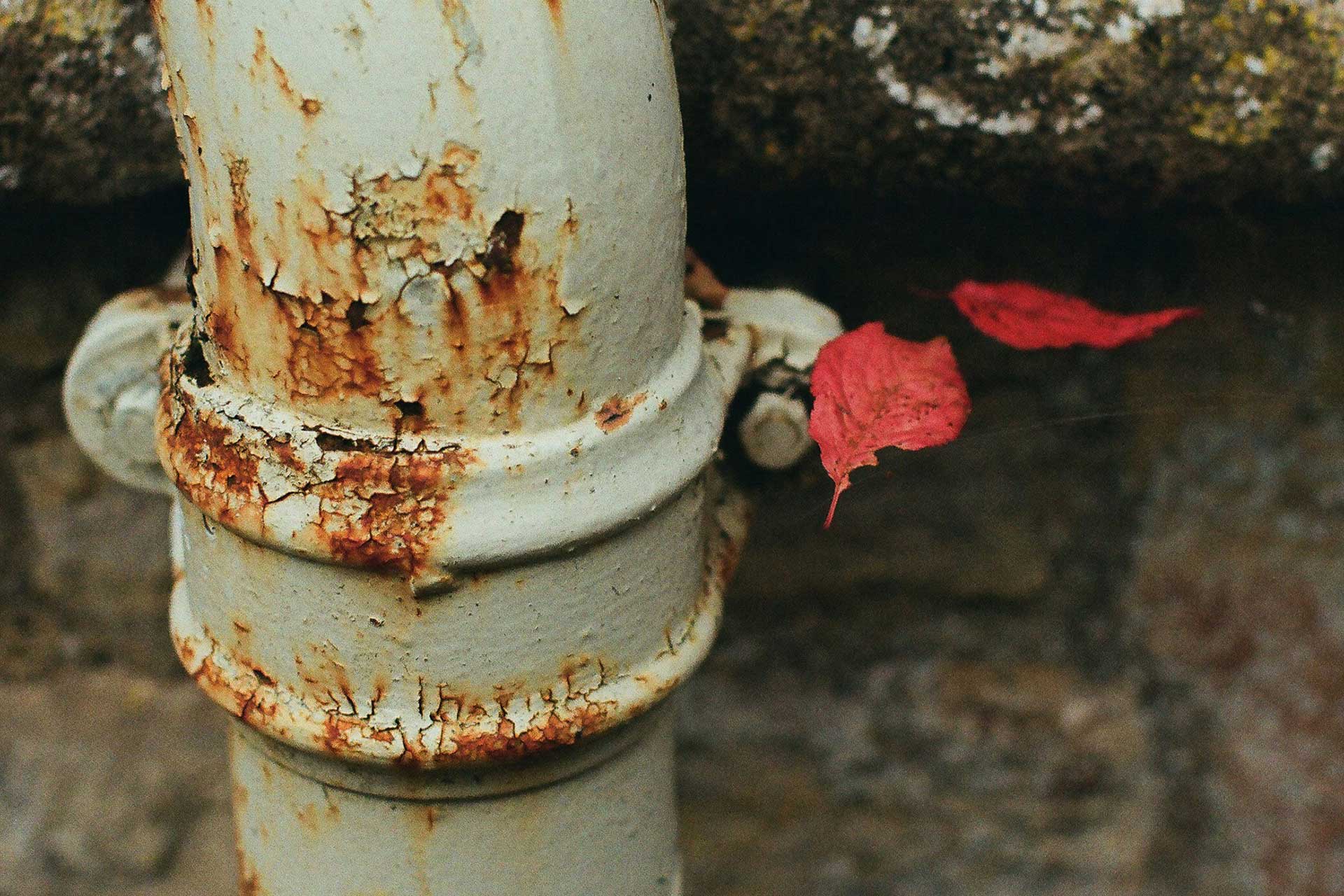 Rusting lead service pipe with visible corrosion near the base, representing aging infrastructure in Cincinnati's water system.