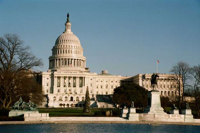 The U.S. Capitol building at sunrise, illustrating Congress’s ongoing government funding crisis.