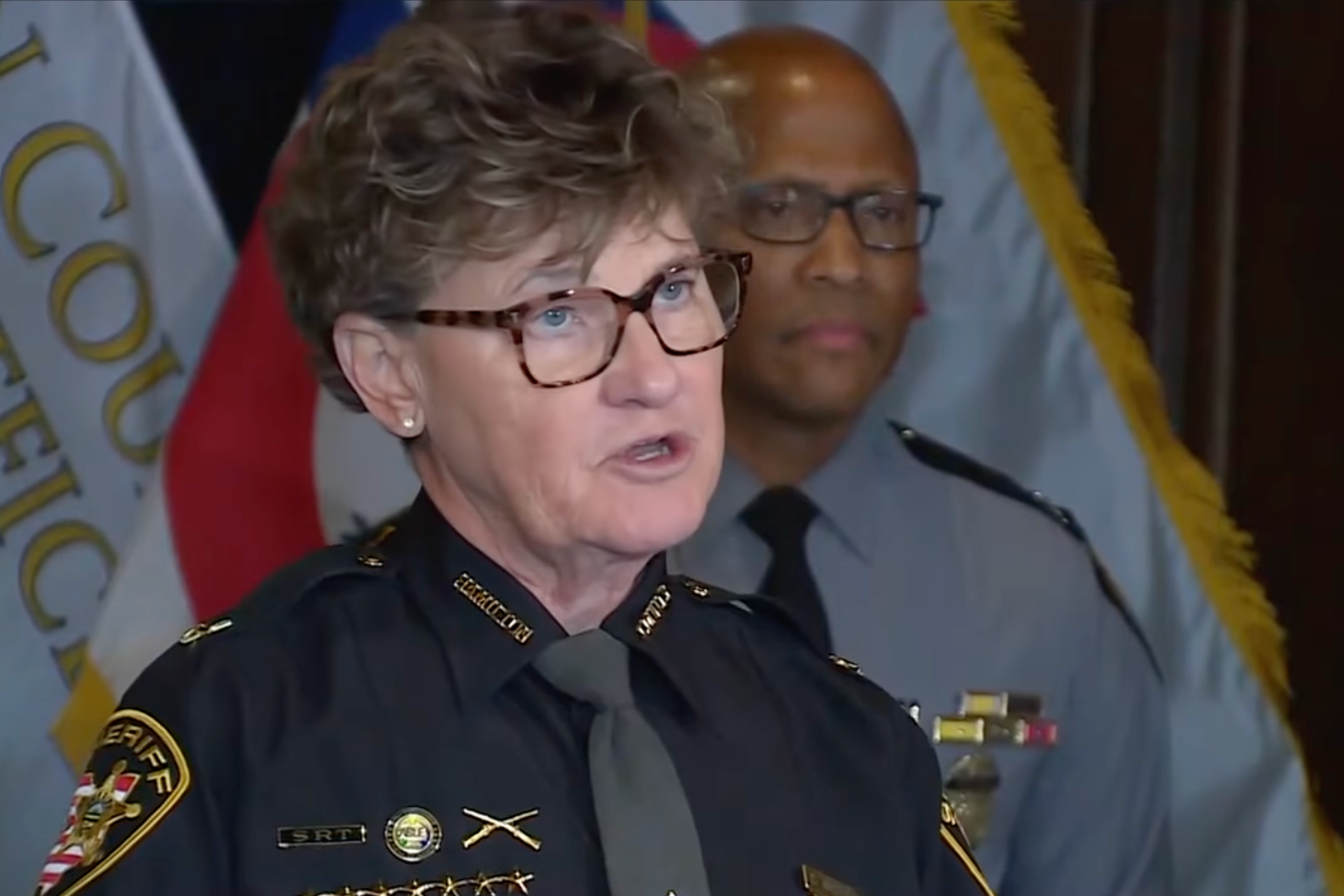 Uniformed police officials speak during a Cincinnati press conference on public safety initiatives.