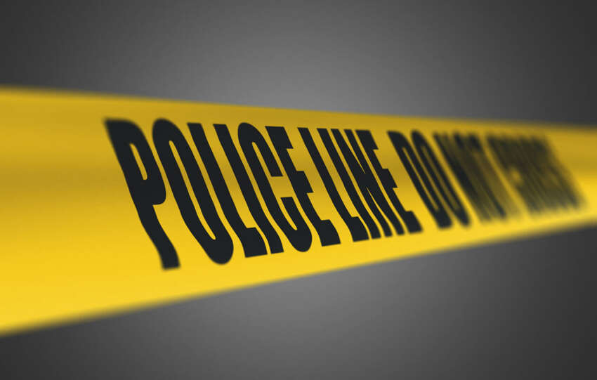 Yellow police tape reading "POLICE LINE DO NOT CROSS" against a dark background, illustrating a crash investigation scene.