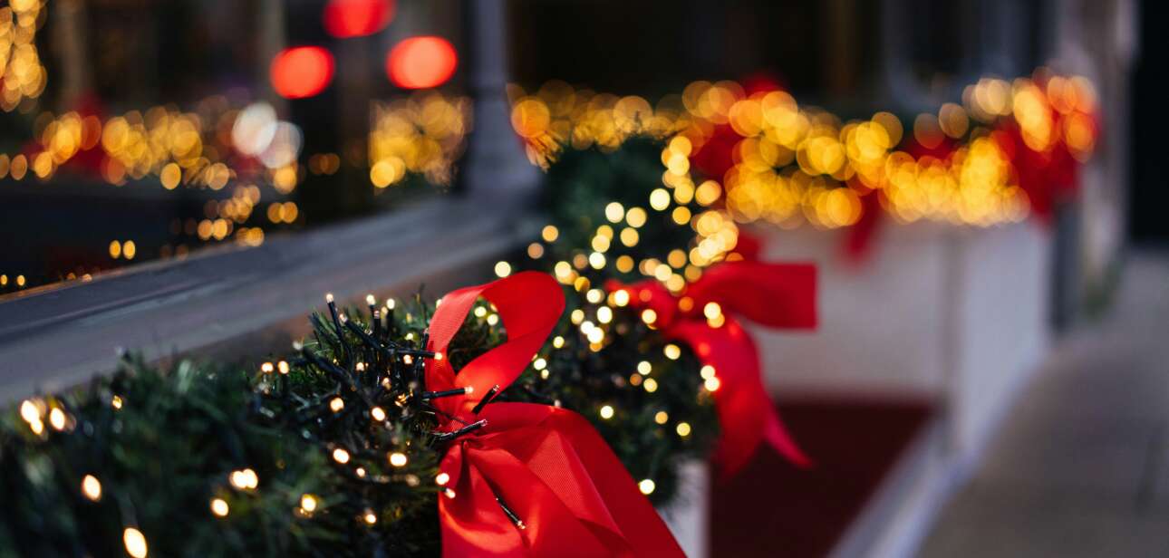 Airport terminal decorated for the holidays with Christmas trees and lights