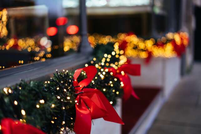 Airport terminal decorated for the holidays with Christmas trees and lights
