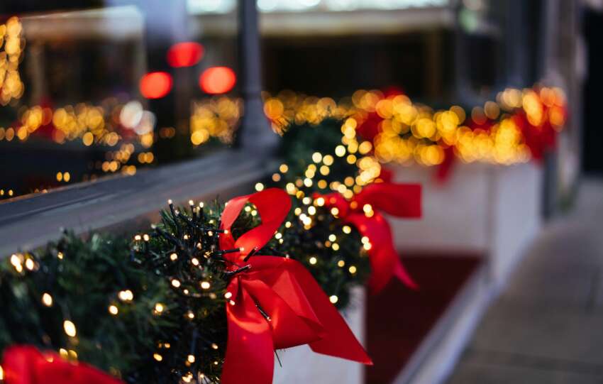 Airport terminal decorated for the holidays with Christmas trees and lights
