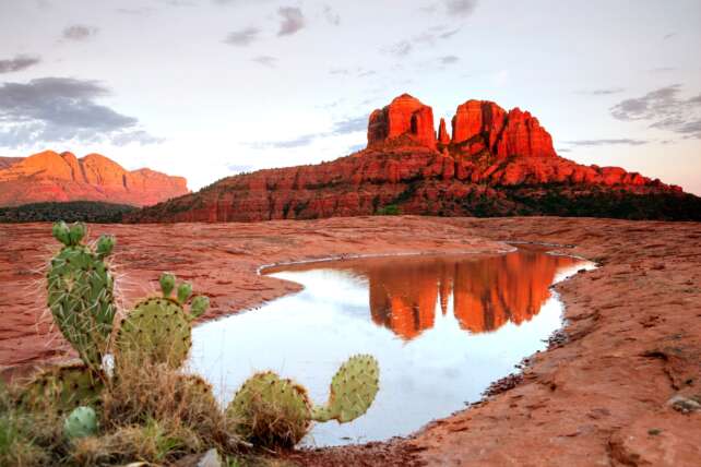 Red rock landscape in Sedona, Arizona with a serene spa retreat in the foreground, perfect for a wellness escape.