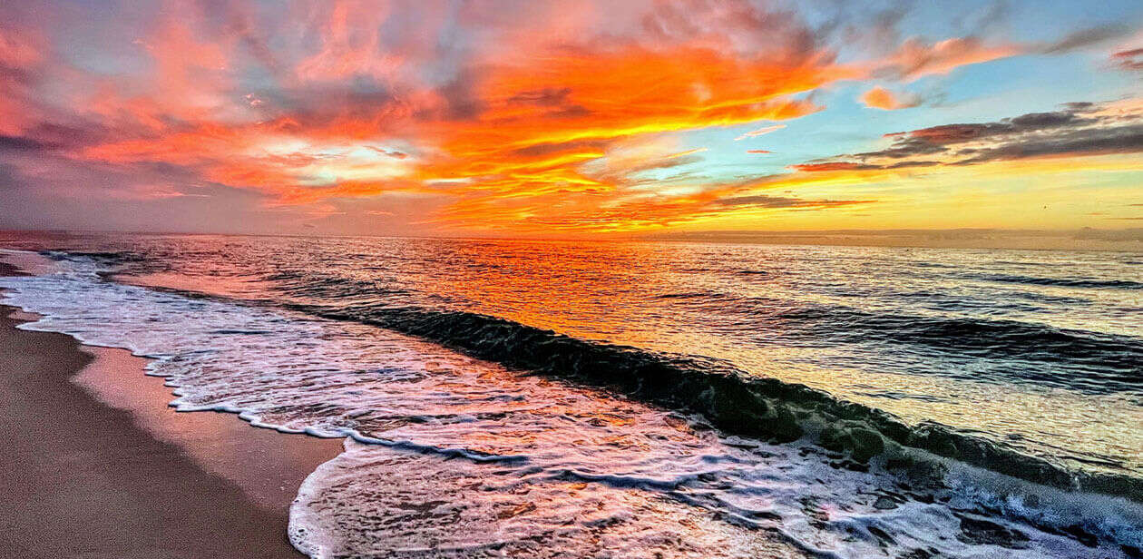 Warm winter sun over a Florida coastline with blue skies and calm water