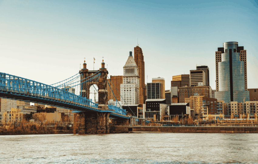 View of the Cincinnati skyline featuring the John A. Roebling Suspension Bridge and the Great American Tower across the Ohio River.