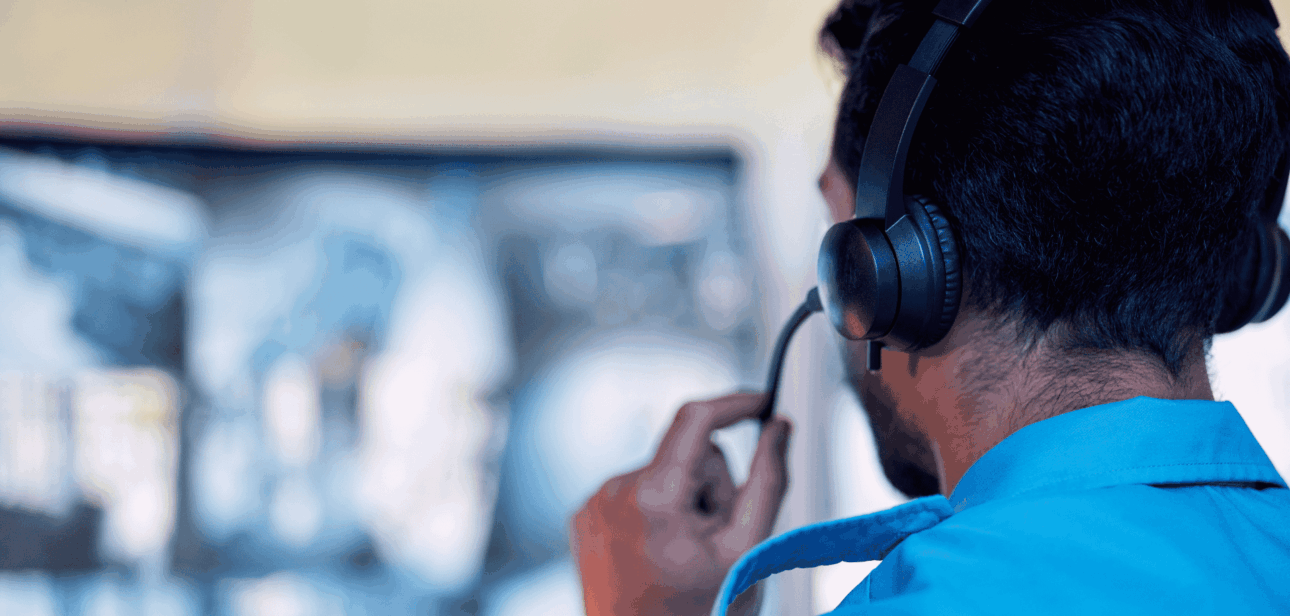 Photo represents a Hamilton County EMA staff member wearing a headset and monitoring screens at the emergency operations center Springdale.