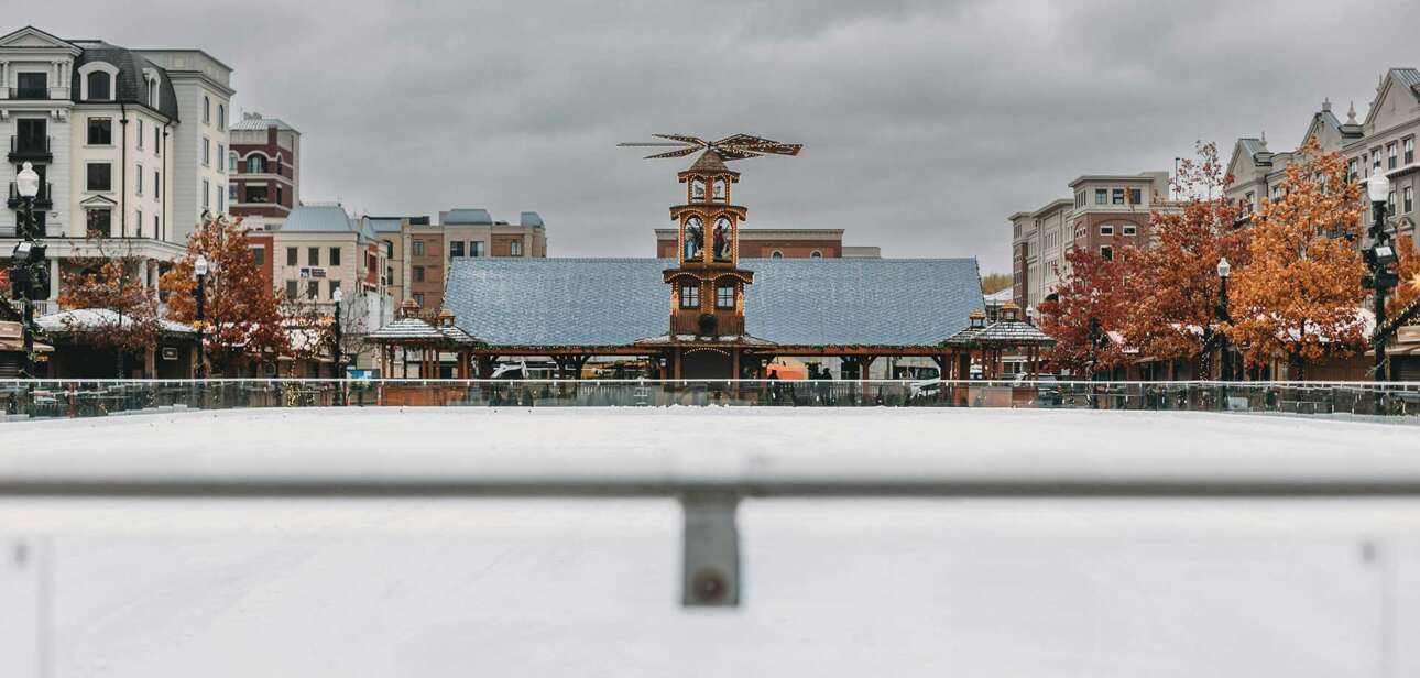 Visitors walk through the Carmel Christkindlmarkt in Indiana with wooden stalls, holiday lights, and a festive winter atmosphere.