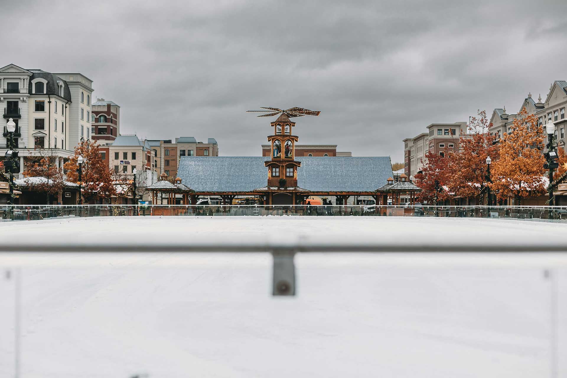 Visitors walk through the Carmel Christkindlmarkt in Indiana with wooden stalls, holiday lights, and a festive winter atmosphere.
