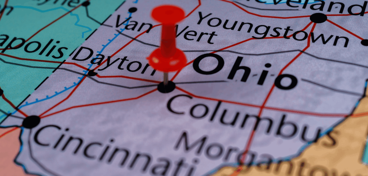 A map of Ohio with a red pushpin on Columbus, highlighting various cities like Cincinnati and Dayton, used for a news article about upcoming 2026 state laws.