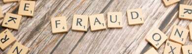 Scattered wooden letter tiles on a table spelling out words like FRAUD, NONPROFIT, TRUST, and LIES, representing concerns over nonprofit fraud and transparency in Cincinnati