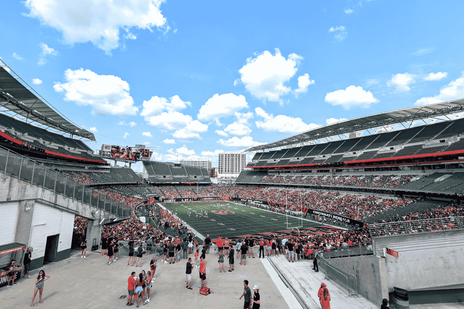 Wide interior view of Paycor Stadium in Cincinnati on a sunny day, showing the seating bowl and open-air design.