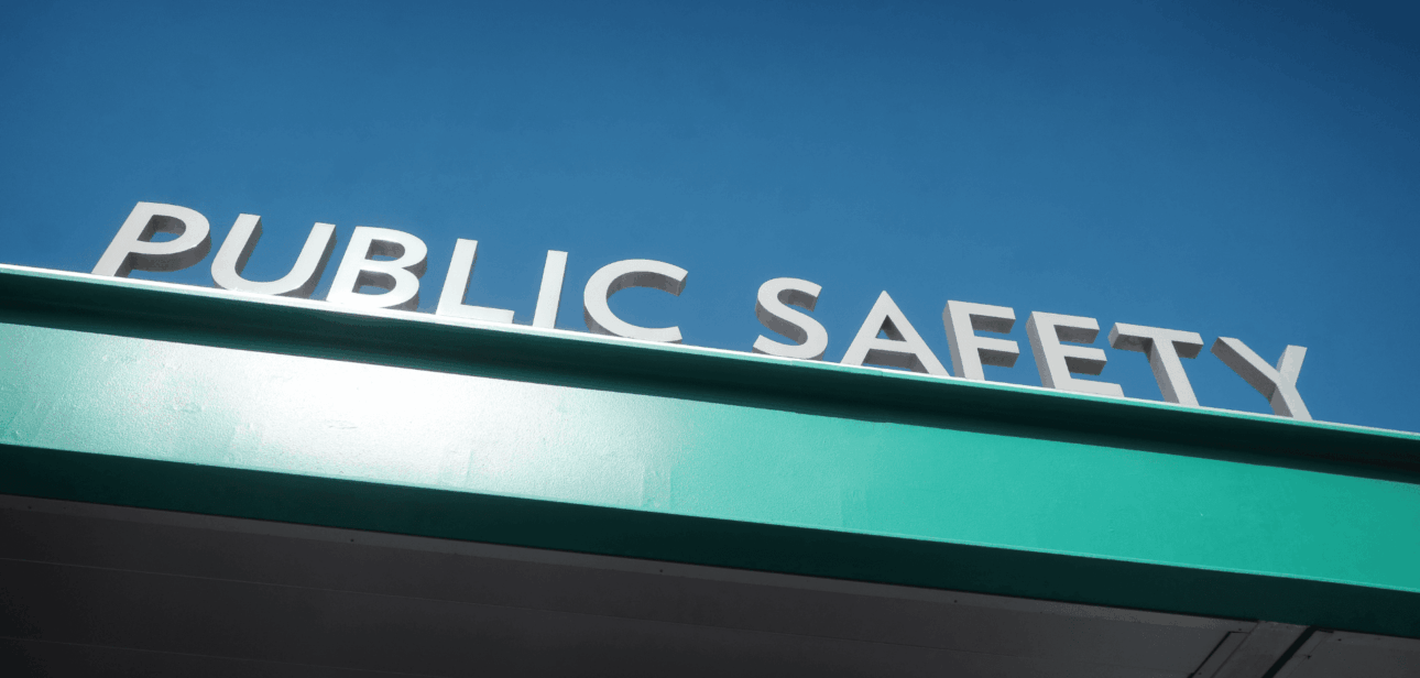 Blue illuminated Public Safety sign on a building exterior that represents public safety issue in Cincinnati.