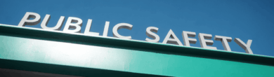 Blue illuminated Public Safety sign on a building exterior that represents public safety issue in Cincinnati.