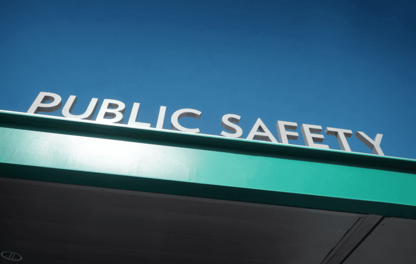 Blue illuminated Public Safety sign on a building exterior that represents public safety issue in Cincinnati.