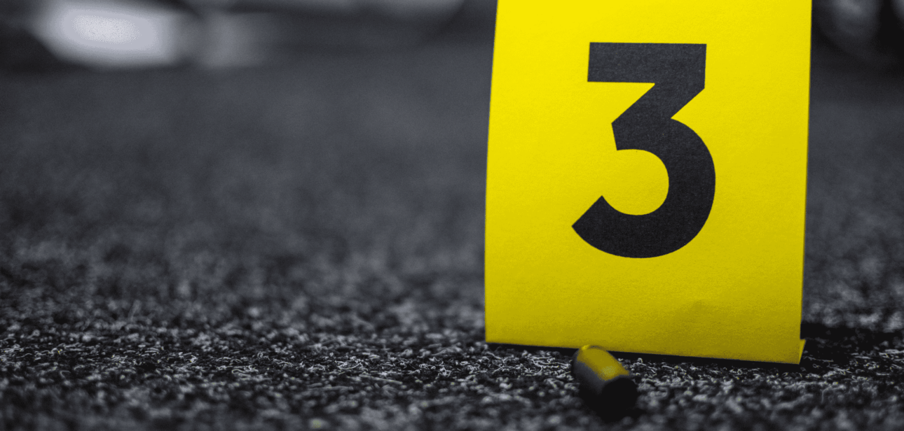 Yellow evidence marker labeled with the number 3 on dark asphalt.