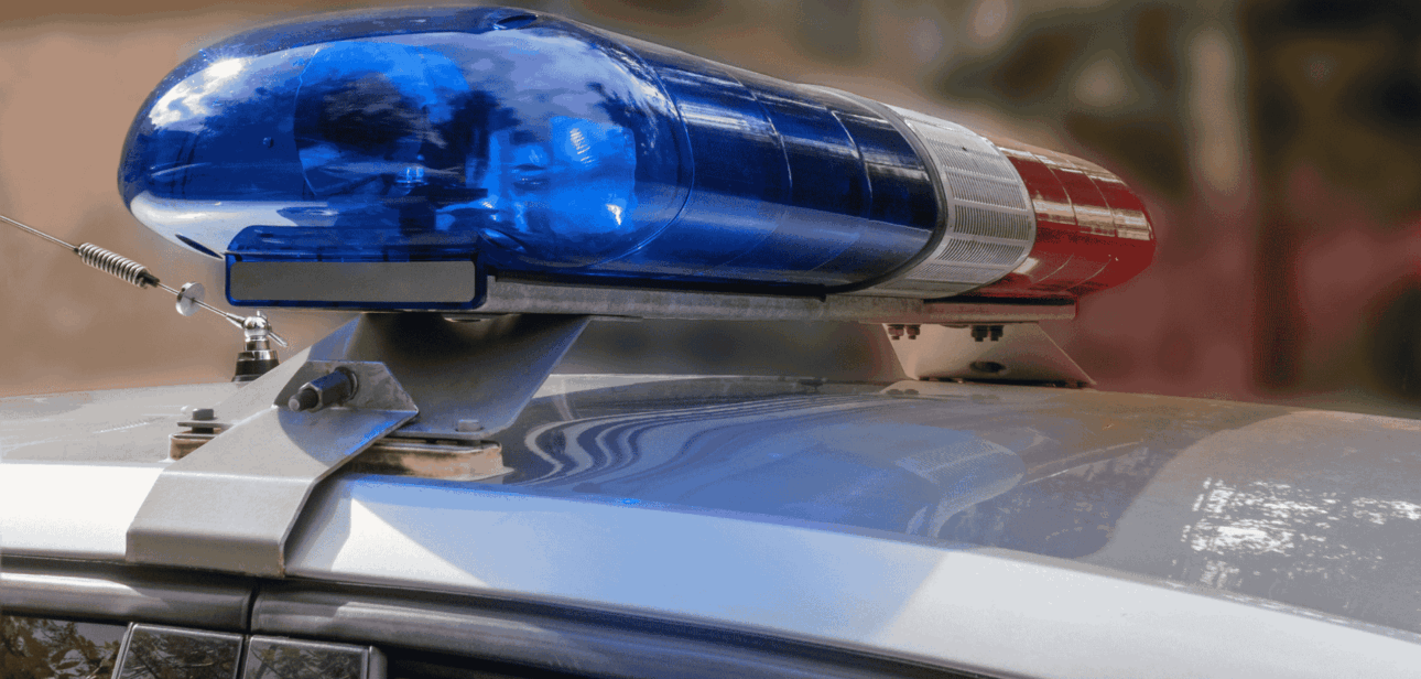 Close-up of blue emergency lights on a police cruiser roof, illustrating Cincinnati Police Department funding news.