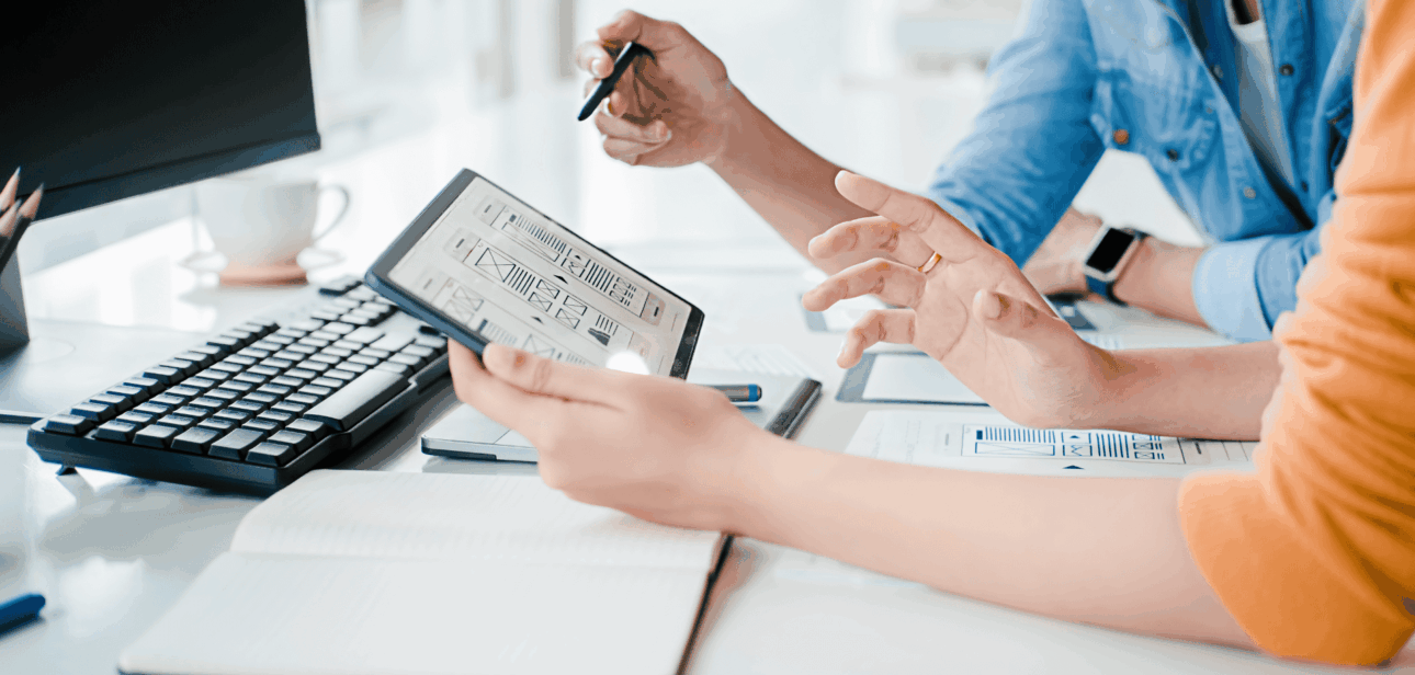 Two professionals collaborating over a digital tablet in a modern Cincinnati office setting, representing the city's growing startup ecosystem.