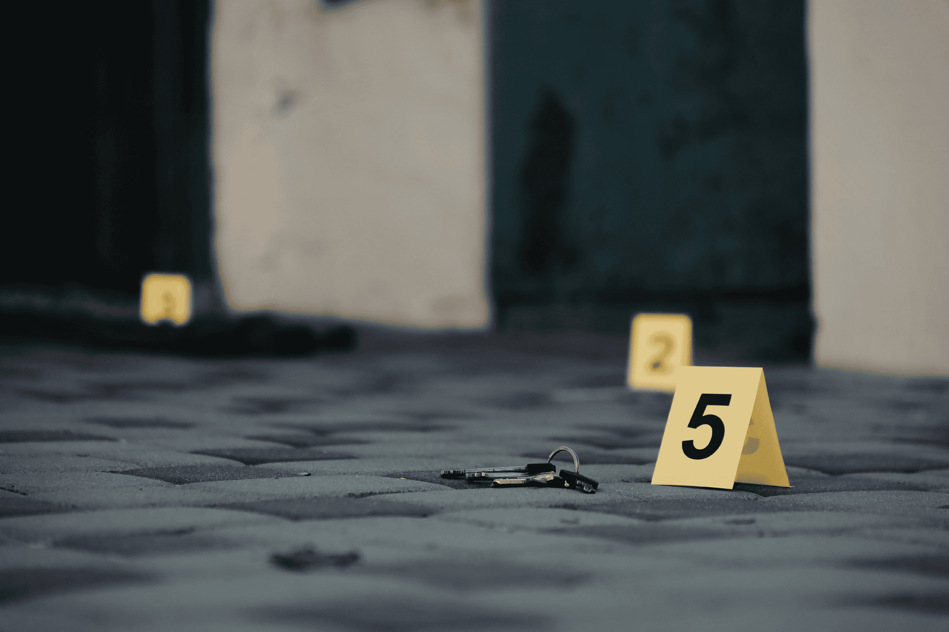Yellow evidence marker and shell casings on a cobblestone street illustrating 2025 Cincinnati shootings data.