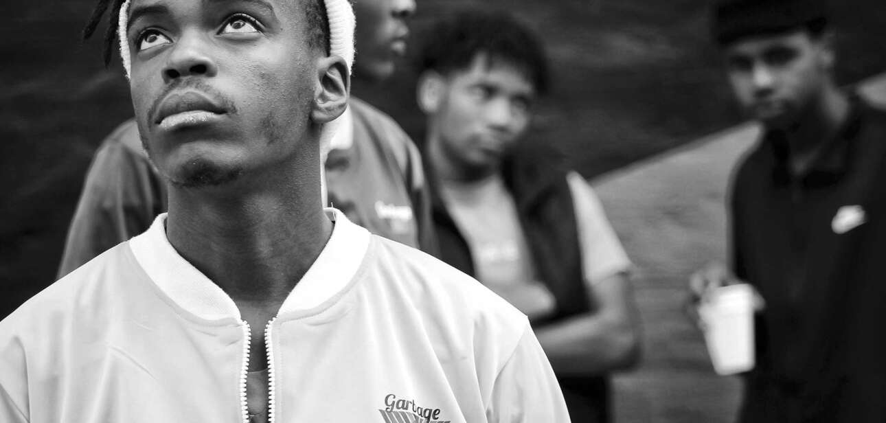 Teenagers gathered outdoors in an urban Cincinnati neighborhood, illustrating concerns around juvenile crime and youth violence