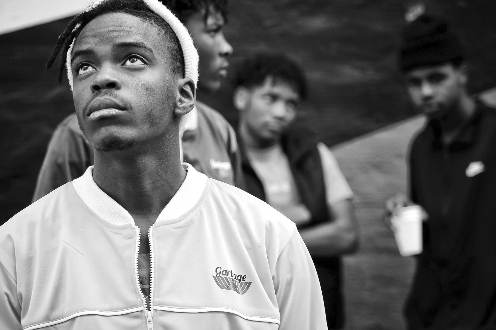 Teenagers gathered outdoors in an urban Cincinnati neighborhood, illustrating concerns around juvenile crime and youth violence