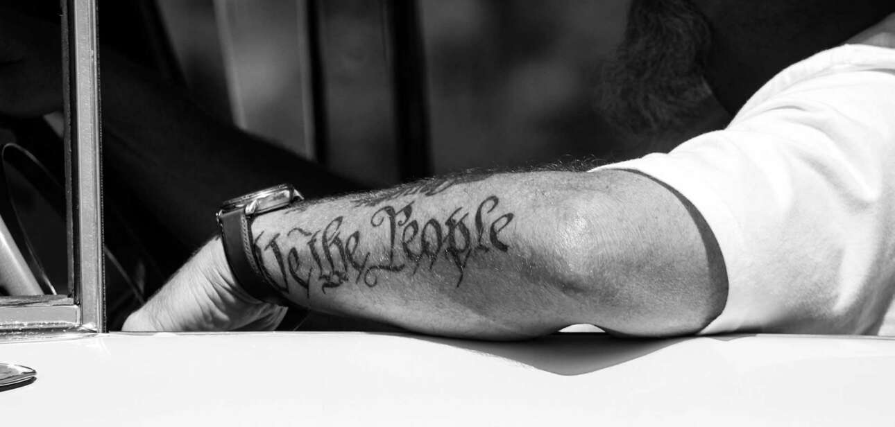 A copy of the U.S. Constitution resting on a wooden table, symbolizing civic reflection and constitutional values in modern America.