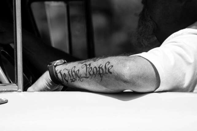 A copy of the U.S. Constitution resting on a wooden table, symbolizing civic reflection and constitutional values in modern America.