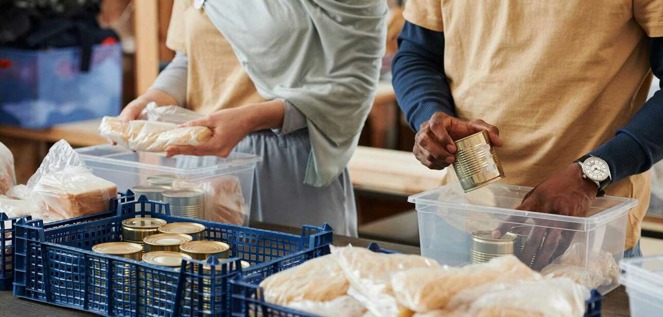 Volunteers preparing meals at a nonprofit organization, illustrating the importance of accountability and trust in charitable work.
