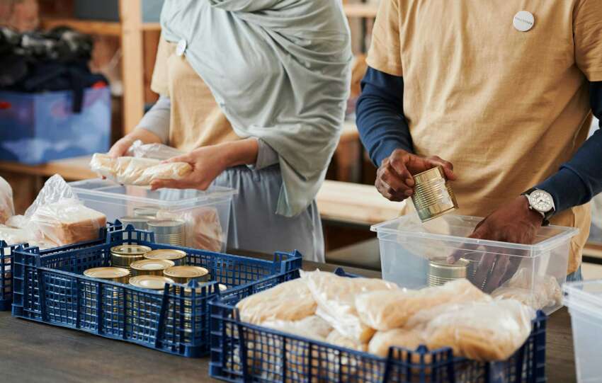 Volunteers preparing meals at a nonprofit organization, illustrating the importance of accountability and trust in charitable work.