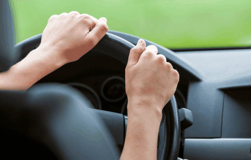 A close-up of a driver's hands on a steering wheel, illustrating the impact of new Ohio BMV registration fees and costs in 2026.
