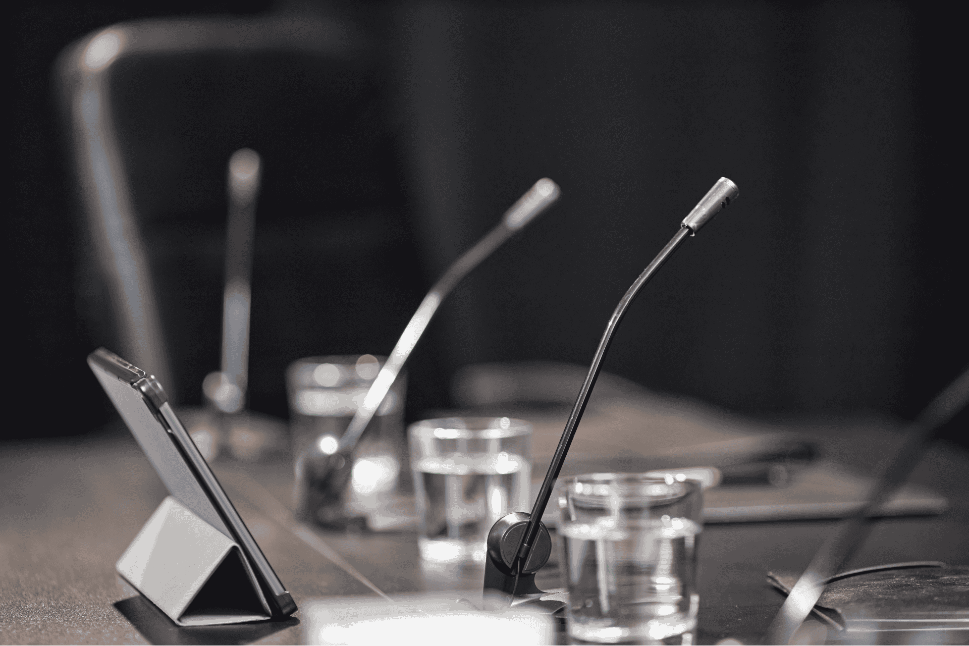 Microphones on a conference table representing secret settlement concerns within Cincinnati City Council.