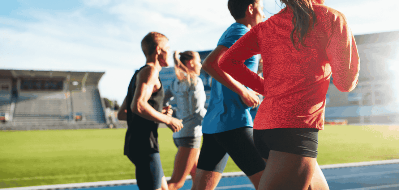 Group of athletes running on an outdoor track, illustrating the debate over transgender athlete bans reaching the U.S. Supreme Court.