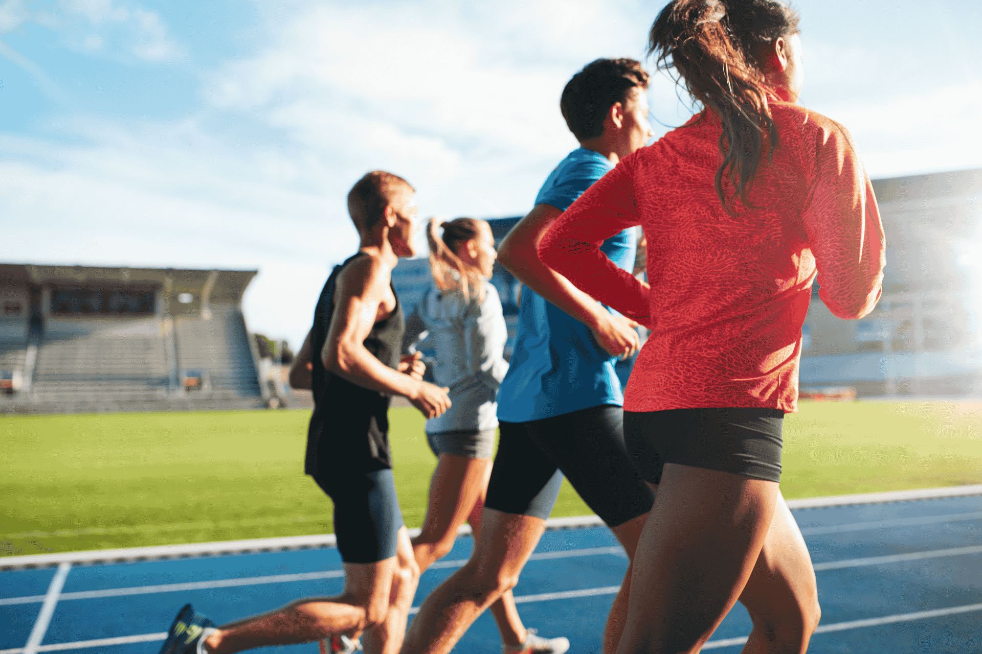 Group of athletes running on an outdoor track, illustrating the debate over transgender athlete bans reaching the U.S. Supreme Court.