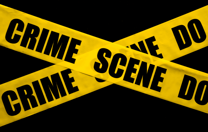 Yellow "Crime Scene Do Not Cross" tape against a dark background, illustrating the violent crime reduction operation in Cincinnati.
