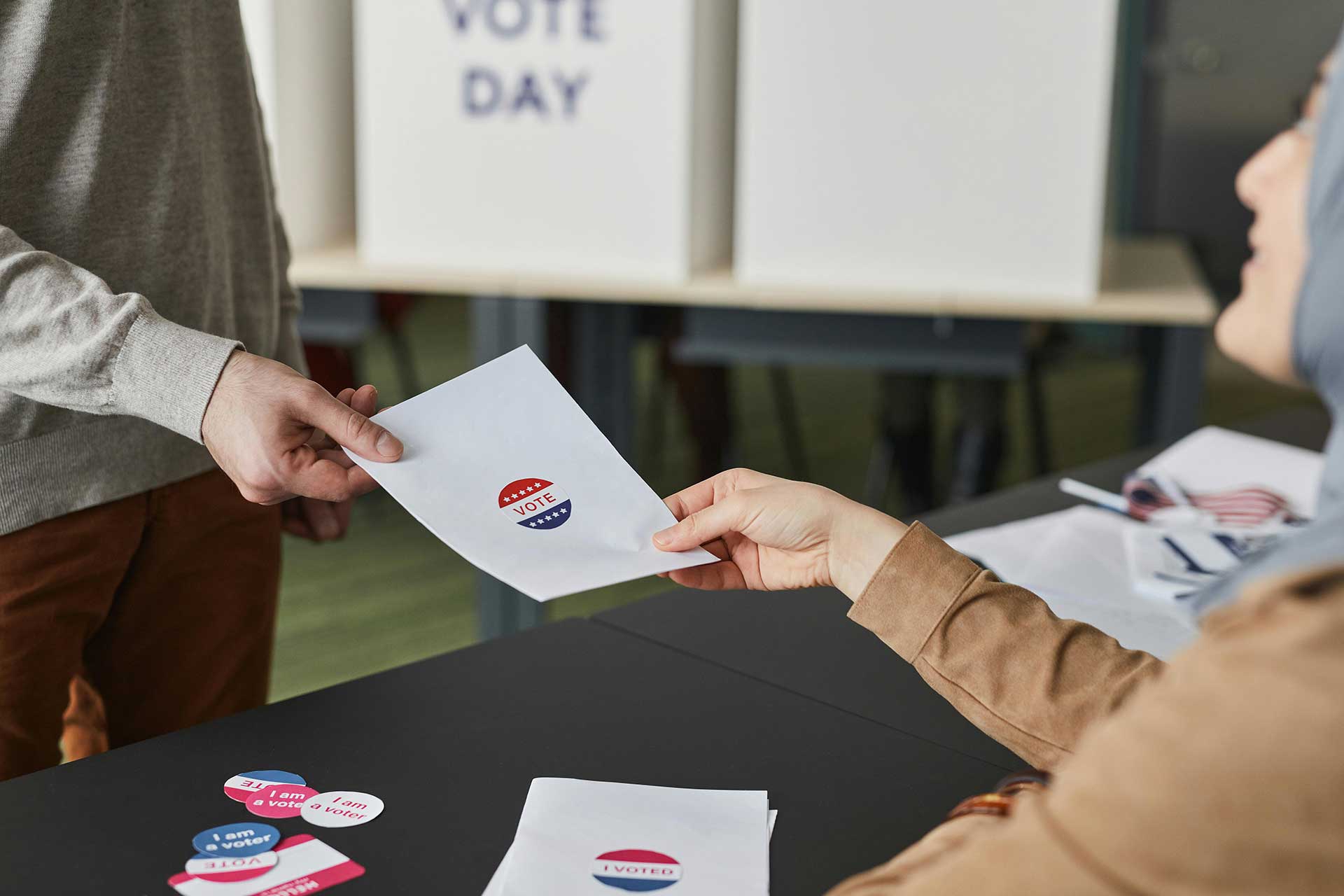 Election worker handling a ballot during routine voter roll maintenance