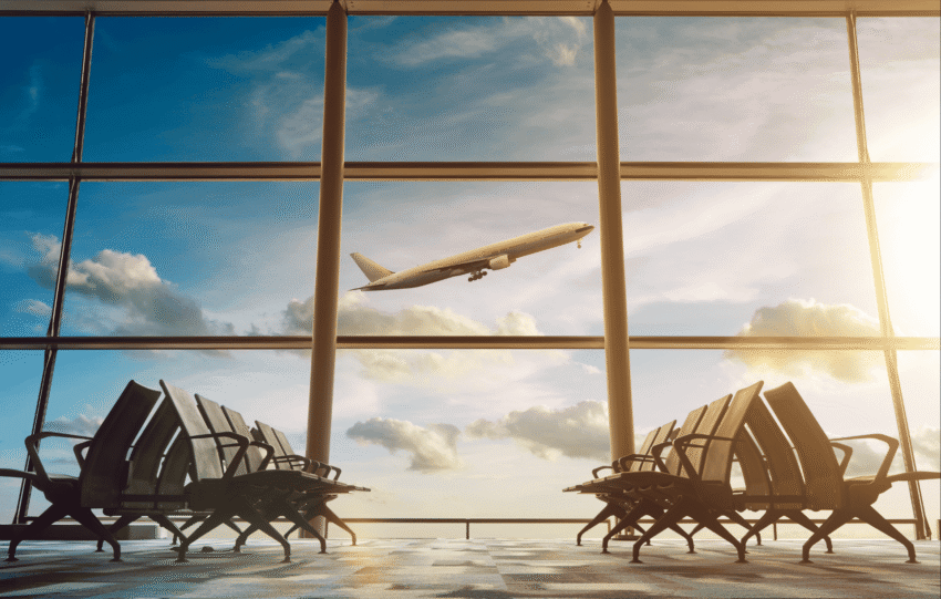 A view of the terminal and tarmac at Cincinnati/Northern Kentucky International Airport (CVG) with a plane taking off, illustrating air travel and passenger volume.