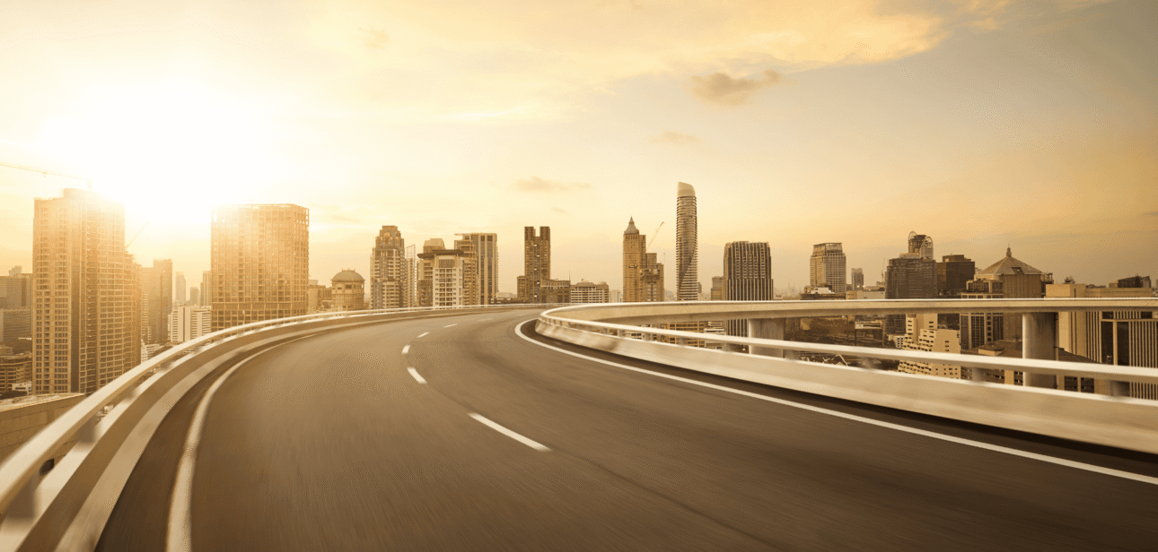 A scenic view of a highway interchange at sunset, representing the I-75 and I-275 improvement project by the Ohio Department of Transportation (ODOT).